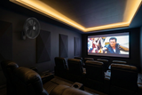 Black Martec Como wall fan, 15% smaller, on the wall of a modern home theatre room